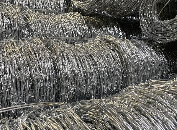 Barbed wire strands for highway fencing tops